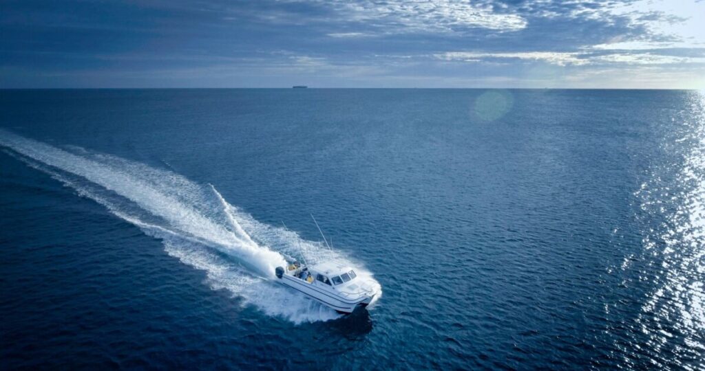 A boat moves across the ocean.