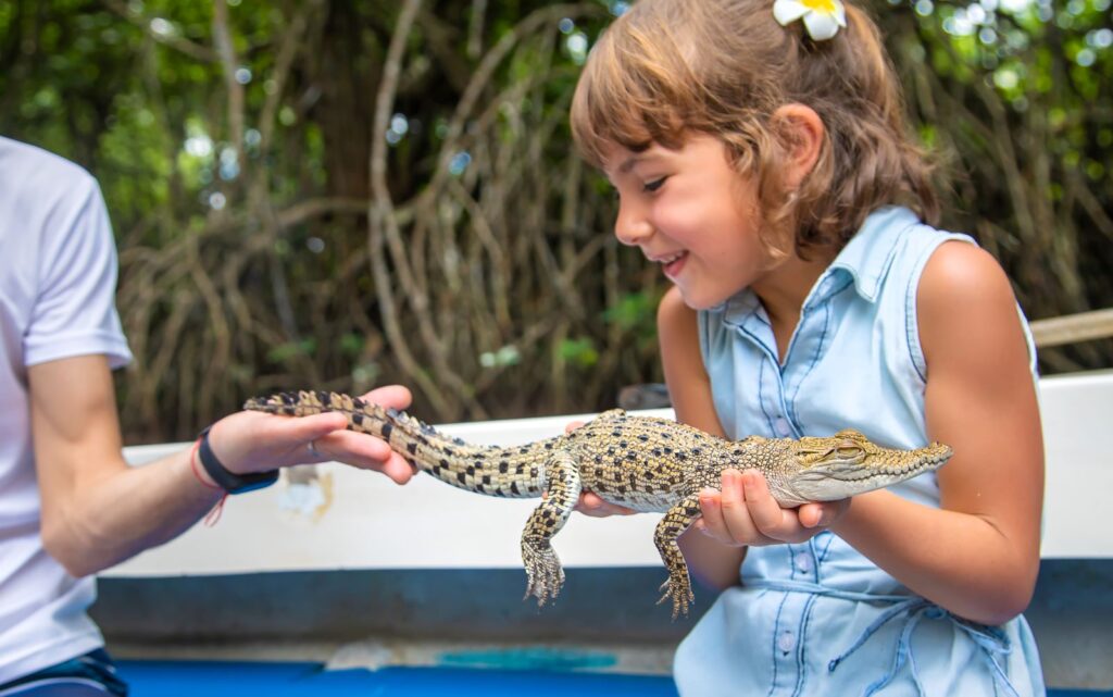 Child holding a reptile