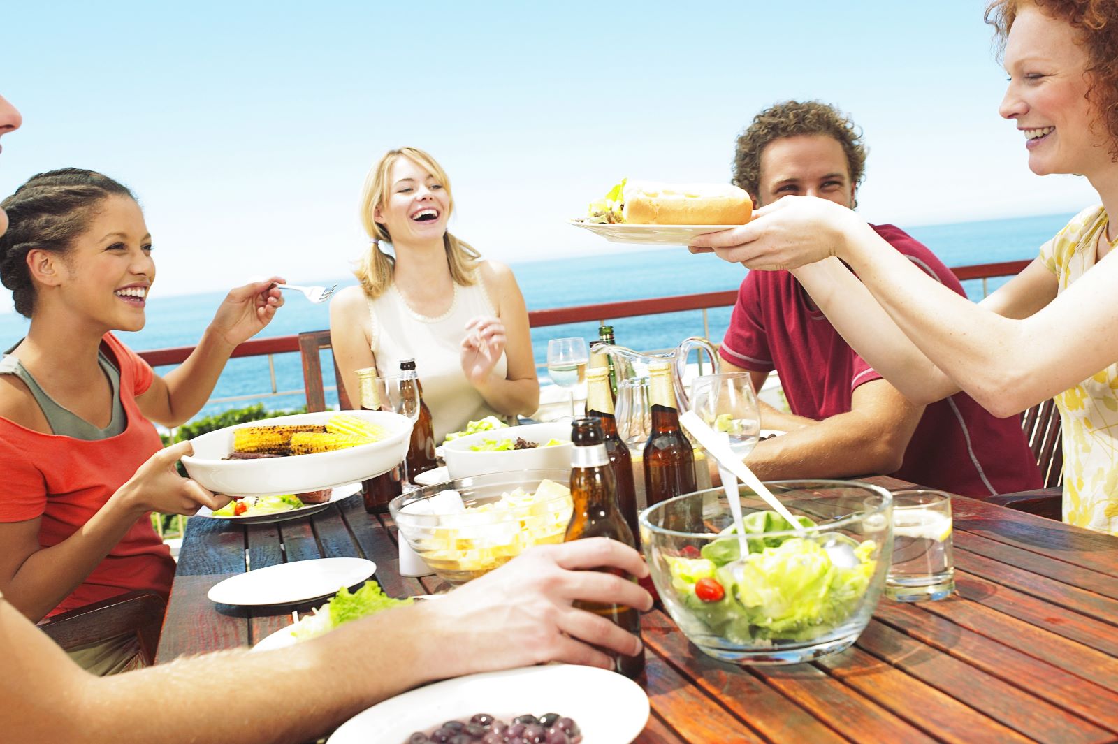 Friends enjoying a meal by the water