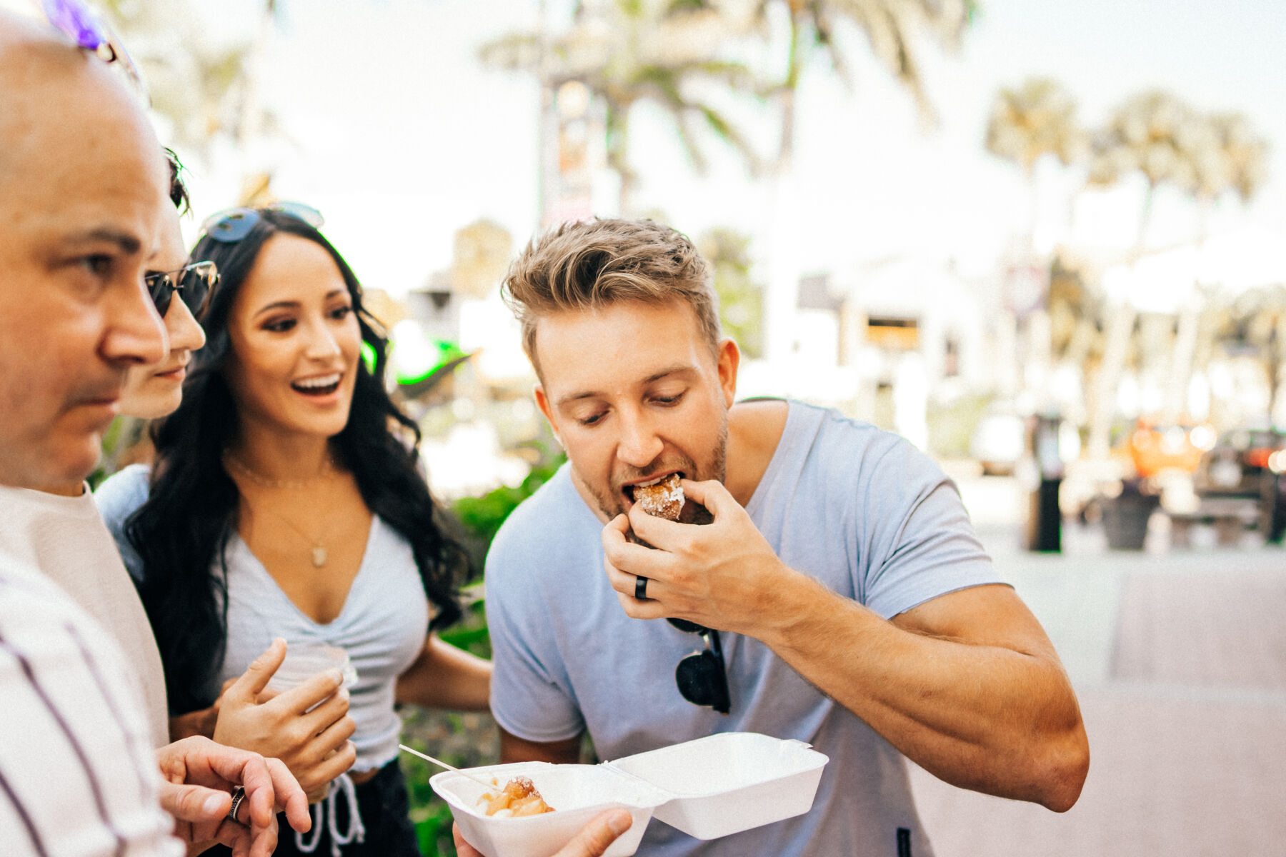 Couple enjoying Meany's Donuts in Siesta Key