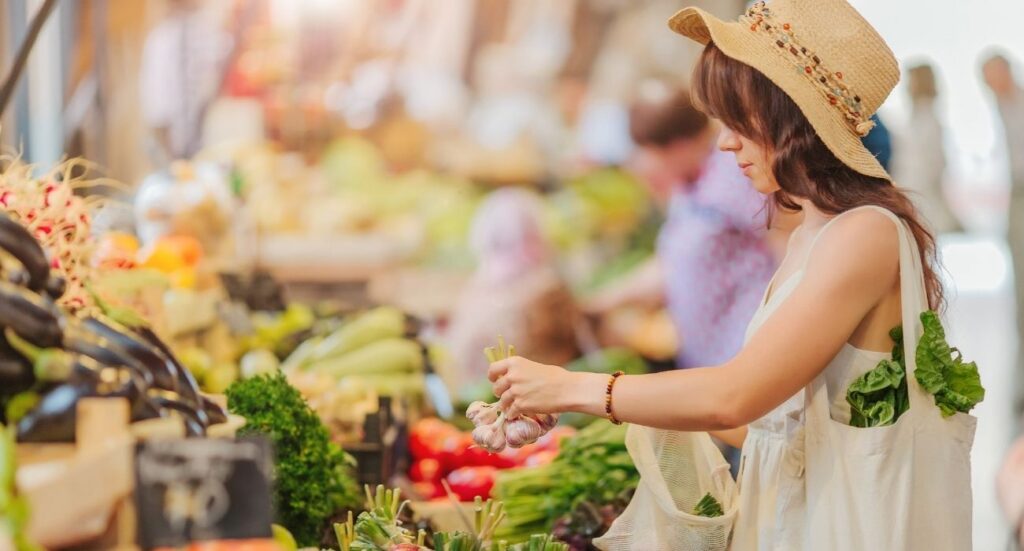 woman selecting vegetables at farmers market